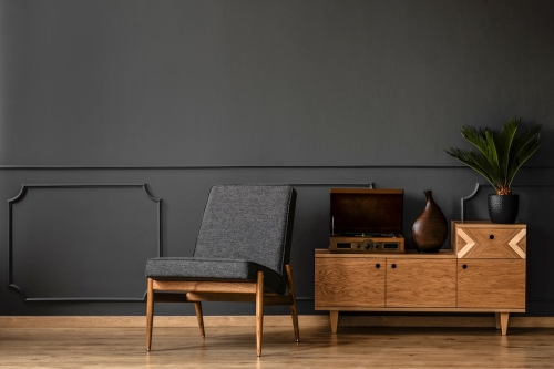 A,Gramophone,On,Wooden,Cabinet,And,Black,Chair,In,Dark