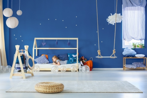 Young,Focused,Girl,Reading,Book,On,Simple,Wooden,Bed,In